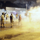 Demonstrators protesting the August 9 police shooting of 18-year-old Michael Brown react as police fire tear gas on the streets of Ferguson, Missouri early on August 17, 2014.
Photo by Joshua LOTT/AFP/Getty Images